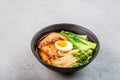 Asian noodle soup, ramen with prawn shrimp, vegetables and egg in black bowl on gray concrete background. Flat lay, Top view, mock Royalty Free Stock Photo