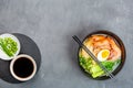 Asian noodle soup, ramen with prawn shrimp, vegetables and egg in black bowl on gray concrete background. Flat lay, Top view, mock Royalty Free Stock Photo