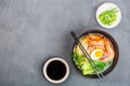 Asian noodle soup, ramen with prawn shrimp, vegetables and egg in black bowl on gray concrete background. Flat lay, Top view, mock Royalty Free Stock Photo