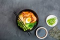 Asian noodle soup, ramen with prawn shrimp, vegetables and egg in black bowl on gray concrete background. Flat lay, Top view, mock Royalty Free Stock Photo