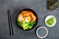 Asian noodle soup, ramen with prawn shrimp, vegetables and egg in black bowl on gray concrete background. Flat lay, Top Royalty Free Stock Photo