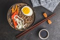 Asian noodle soup with soba noodles, vegetable and egg in bowl