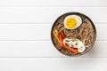 Asian noodle soup with soba noodles, vegetable and egg in bowl