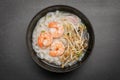 Asian Noodles with shrimps and seafood in black bowl