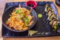 Asian noodles and sushi in black bowl Royalty Free Stock Photo