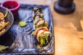 Asian noodles and sushi in black bowl Royalty Free Stock Photo