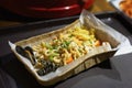 Asian noodles wok with seafood, fresh oysters in a paper plate in a dark tray. Delicious and fresh food. Gastronomic