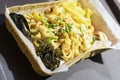 Asian noodles wok with seafood, fresh oysters in paper plate. Delicious, fresh food. Gastronomic gourmet dainty products