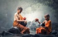 Asian Novice monks cleaning alms bowl