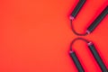 Asian Nunchaku weapon on a red background and a place for text