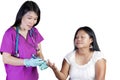 Asian Nurse checking glucose