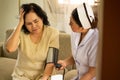 Nurse doing pressure measuring for female patient who hasing headache in the room