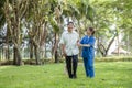 Asian Nurse Female Caregiver Help Support Older Adult Patient and Provide Encouragement During Treatment. Rehabilitation or Royalty Free Stock Photo