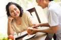 Asian nurse peeling apple for adult female patient in the room Royalty Free Stock Photo