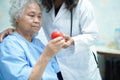 Asian nurse physiotherapist doctor care, help and support senior or elderly old lady woman patient at hospital Royalty Free Stock Photo