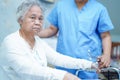 Asian nurse physiotherapist doctor care, help and support senior or elderly old lady woman patient at hospital ward Royalty Free Stock Photo