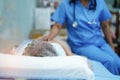 Asian nurse physiotherapist doctor care, help and support senior or elderly old lady woman patient at hospital ward Royalty Free Stock Photo