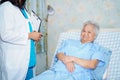 Asian nurse physiotherapist doctor care, help and support senior or elderly old lady woman patient at hospital Royalty Free Stock Photo