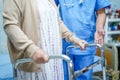 Asian nurse physiotherapist doctor care, help and support senior or elderly old lady woman patient lie down in bed at hospital war Royalty Free Stock Photo