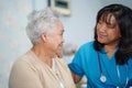 Asian nurse physiotherapist doctor care, help and support senior or elderly old lady woman patient lie down in bed at hospital war Royalty Free Stock Photo
