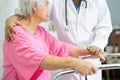 Asian nurse physiotherapist doctor care, help and support senior or elderly old lady woman patient walk with walker at hospital Royalty Free Stock Photo