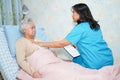 Asian nurse physiotherapist doctor care, help and support senior or elderly old lady woman patient Royalty Free Stock Photo