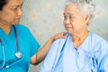 Asian nurse physiotherapist doctor touching Asian senior or elderly old lady woman patient with love Royalty Free Stock Photo