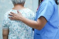 Asian nurse physiotherapist doctor touching Asian senior or elderly old lady woman patient with love, care, helping, Royalty Free Stock Photo