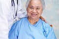 Asian nurse physiotherapist doctor touching Asian senior or elderly old lady woman patient with love  care  helping  encourage and Royalty Free Stock Photo