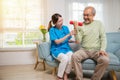 Asian nurse physiotherapist helping senior man in lifting dumbell at retirement Royalty Free Stock Photo