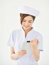 Asian nurse is smiling and holding digital tablet. Royalty Free Stock Photo