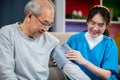 Asian nurse visit patient senior man at home she measuring arterial blood pressure on arm Royalty Free Stock Photo