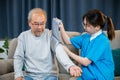 Asian nurse visit patient senior man at home she measuring arterial blood pressure on arm Royalty Free Stock Photo