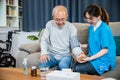 Asian nurse visit patient senior man at home she measuring arterial blood pressure on arm Royalty Free Stock Photo