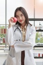 Asian nutritionist doctor woman showing red apple in right hand in laboratory room Royalty Free Stock Photo