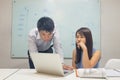 Asian office employee reading financial number on laptop