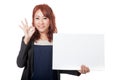 Asian office girl happy show a blank sign and OK sign with her h