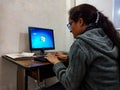 an asian office staff female executive working at desktop computer in india January 2020