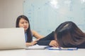 Asian office woman worry about tired workmate