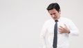 Asian office worker holding his chest, suffering from heart pain, heart attack, stressful working, caused by high blood pressure Royalty Free Stock Photo