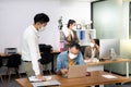 Asian office workers wearing face masks working in new normal office and doing social distancing Royalty Free Stock Photo