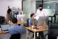 Asian office workers wearing face masks working in new normal office and doing social distancing during corona virus Royalty Free Stock Photo