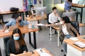 Asian office workers wearing face masks working in new normal office and doing social distancing Royalty Free Stock Photo