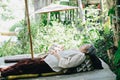 Old asian elderly senior elder woman sleeping in garden Royalty Free Stock Photo