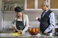 Asian old couple talking chatting in kitchen Royalty Free Stock Photo