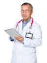 Asian old doctor use of digital tablet Royalty Free Stock Photo