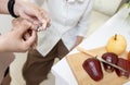 Asian old elderly cut her finger with a knife while slicing fruit,hands of female caregiver giving first aid to senior woman,wound Royalty Free Stock Photo