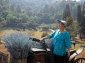 Asian old elderly elder senior woman posing on old vintage retro antique horse carriage Royalty Free Stock Photo