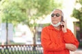 Asian old asian elderly senior elder man talking on smart mobile phone Royalty Free Stock Photo