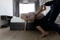 Asian old elderly with vertigo trying to stand up after dizziness loss of balance or staggered symptoms of faint dizzy teen girl Royalty Free Stock Photo